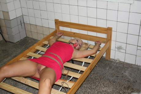 Poor blonde Veronica with nude pretty vagina tied up on strange bed