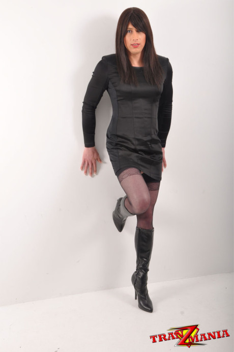 Ravishing crossdresser with long ebony hair posing