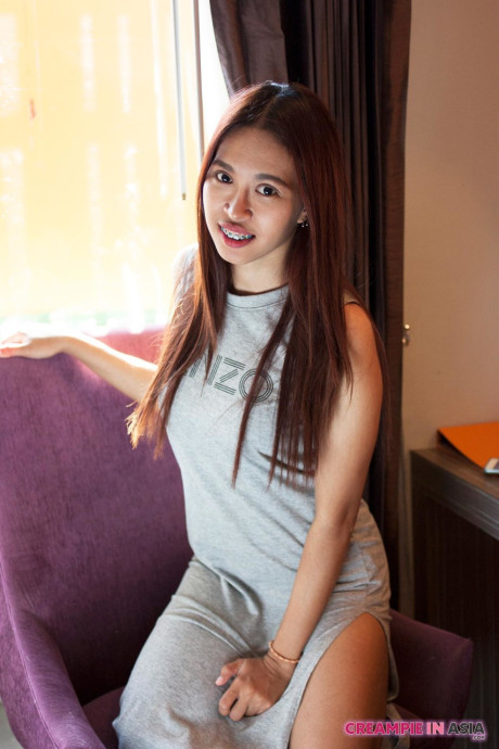Pretty asian babe Ploy	strips & shows her tiny tits and hairy twat