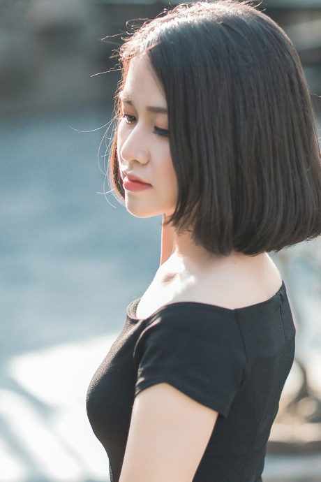 Glamorous chinese babe posing in her elegant ebony dress in public