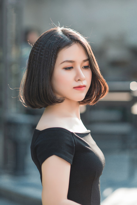 Glamorous chinese babe posing in her elegant ebony dress in public