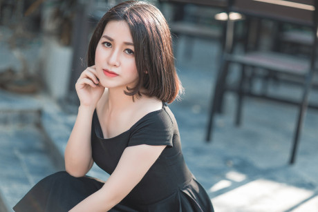 Glamorous chinese babe posing in her elegant ebony dress in public