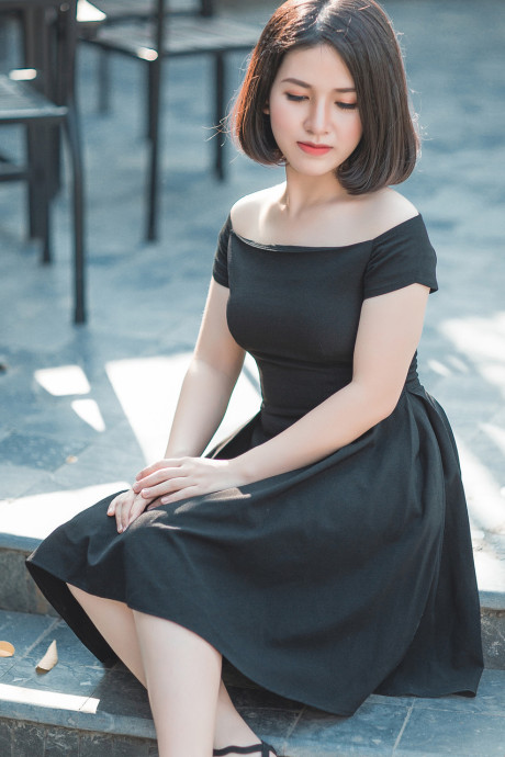 Glamorous chinese babe posing in her elegant ebony dress in public