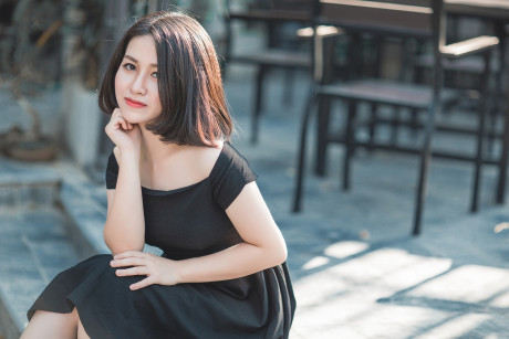 Glamorous chinese babe posing in her elegant ebony dress in public