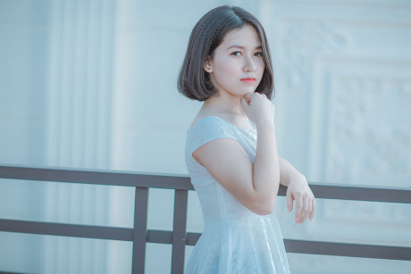 Glamorous chinese babe posing in her elegant ebony dress in public