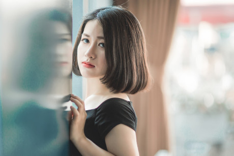 Glamorous chinese babe posing in her elegant ebony dress in public