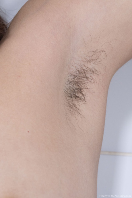 Curvy babe Tiffany spreads her hairy snatch up close during a fine striptease