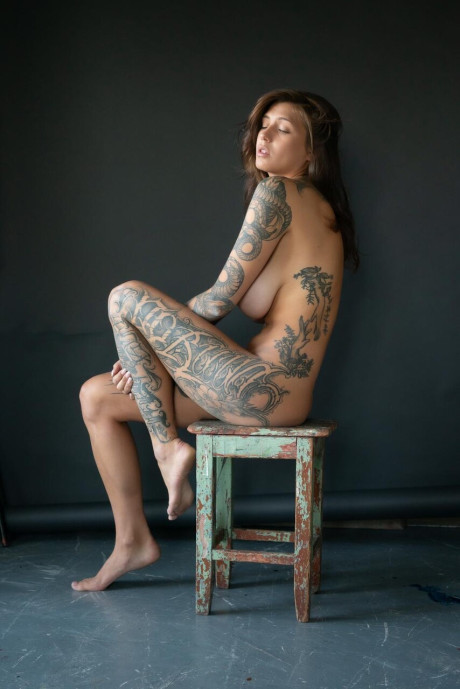 Tattooed chick lady poses in her underthings as well as undressed albeit in a SFW manner