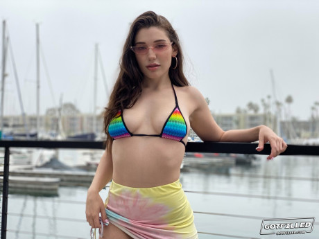 Brunette girl broad Lily Lou models a bikini at a marina before rough sex inside
