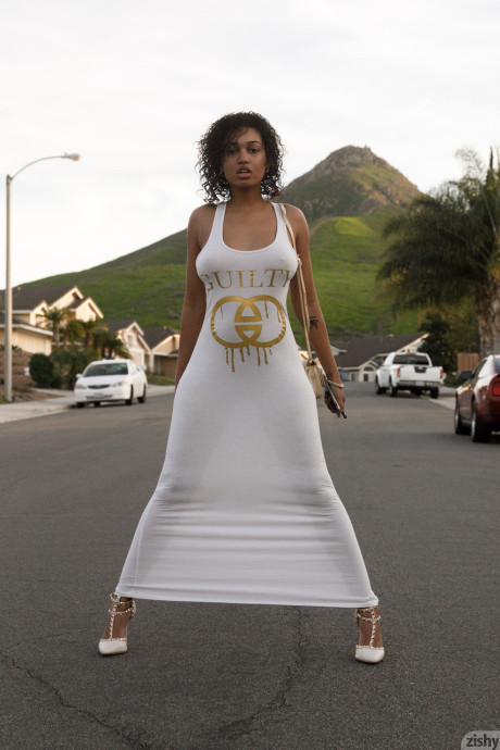 Black Noelle Monique hikes up her white dress & flashes her pussy & massive tits