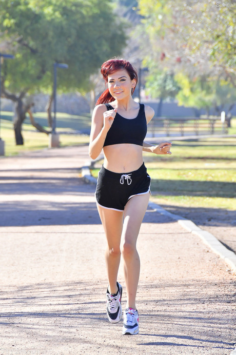 Frisky redhead teenie Sabina strips in public and does yoga butt naked