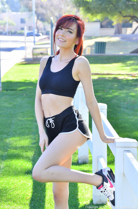 Frisky redhead teenie Sabina strips in public and does yoga butt naked