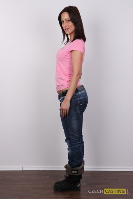 Amateur model with brunette hair stands straight and firm after getting nude