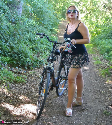 Busty plump cougar Chrissy bicycling topless with her enormous massive boobies swaying