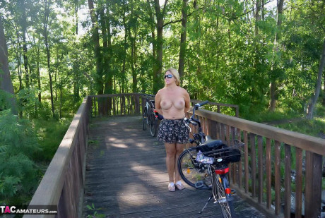 Busty plump cougar Chrissy bicycling topless with her enormous massive boobies swaying