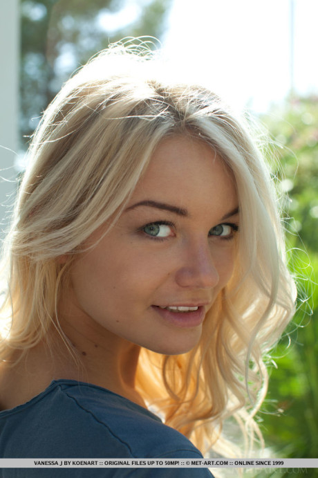 Fine blonde teen Vanessa J models in the undressed on pathway beside a house