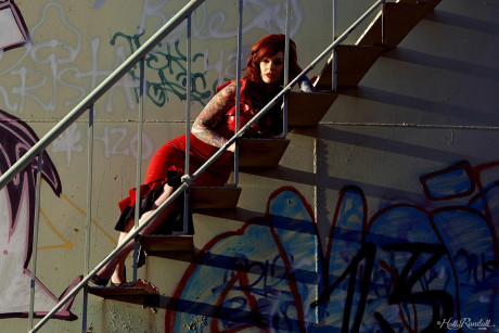 Goth slut gf chick Vanessa Lake peels off red latex dress on stairs of chemical tank
