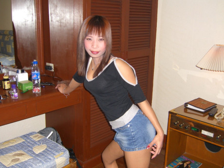 Chinese ginger head strips down to her sandals on top of a motel room bed