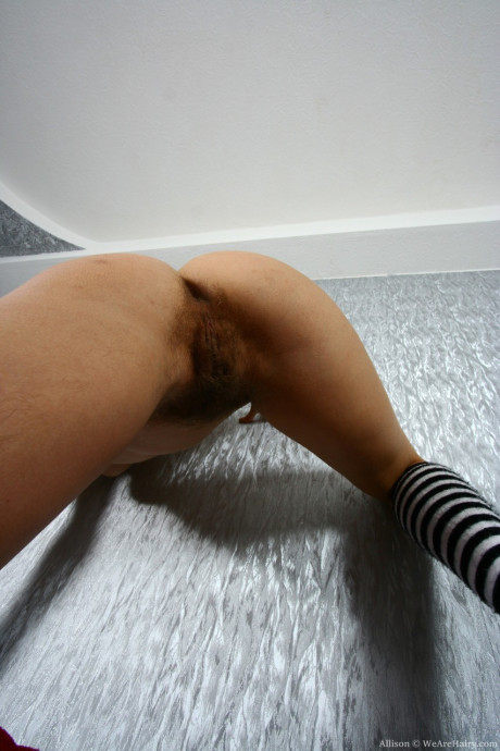 Thin blondy Allison reveals her furry beaver in a solo striptease session