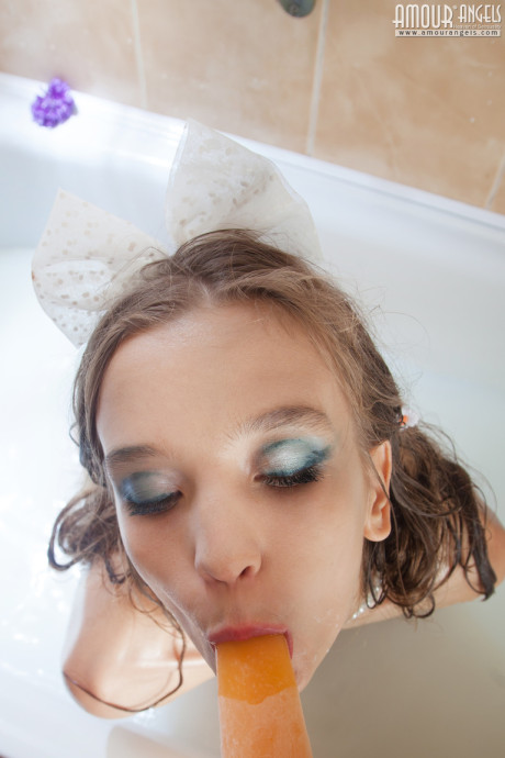 Tiny young slut girl lady Alisabelle pours milk over her naked body while taking a bath