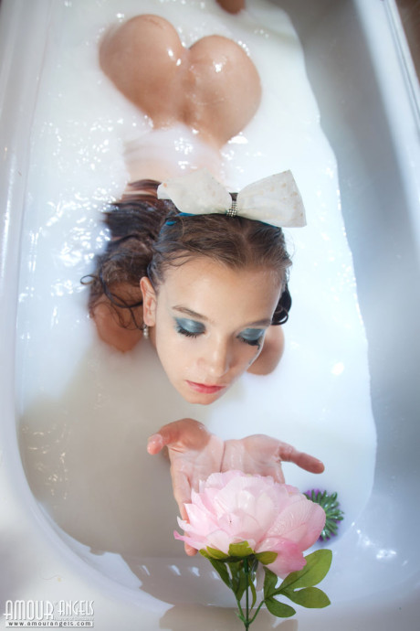 Tiny young slut girl lady Alisabelle pours milk over her naked body while taking a bath