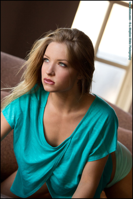 Pretty blonde Alyssa Branch gets completely undressed on a fabric sofa