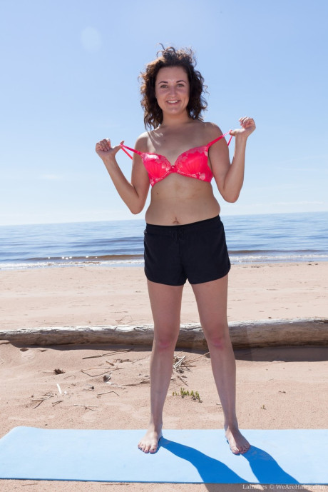 First timer Laimites spreads her bushy cunt thick open at the beach