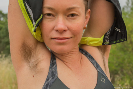 Amateur bicyclist Jiz Lee strips in nature and showcases her hairy body